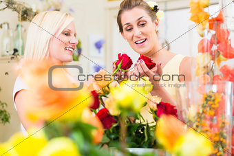 Women in the flower store buying roses