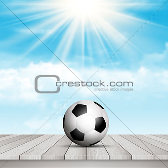 Football / soccer ball on table against blue sky 