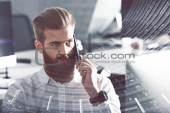 Businessman talking to the phone in office. double exposure