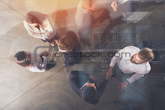 Handshaking business person in office. concept of teamwork and partnership. double exposure
