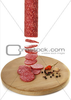 Sliced sausage on a board with spices