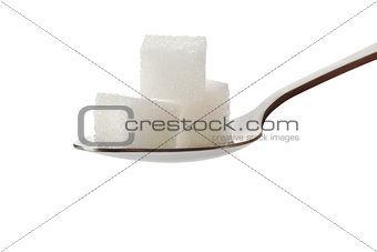Three cubes of sugar on a spoon