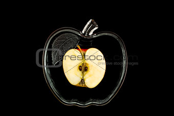 sliced apple in a glass bowl on a black background