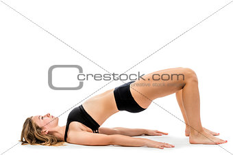 young girl doing exercises in underwear on a white background