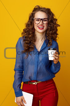 woman on yellow background with coffee cup and tablet PC