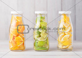 Bottles with oranges with limes and lemons slices 