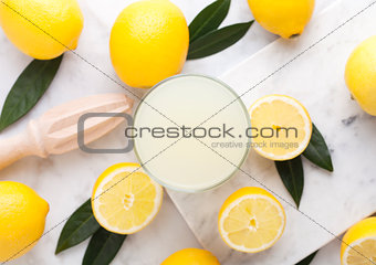 Glass of organic fresh lemon juice and fruits