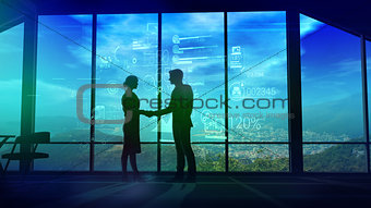 Business partners shake hands on the background of corporate infographics