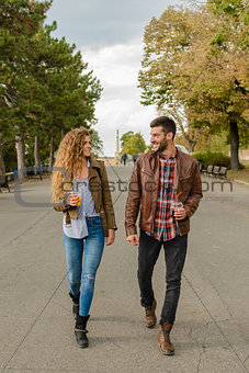 Young couple walking in the city park