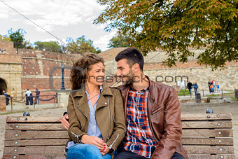 Happy young couple relaxing in the public park