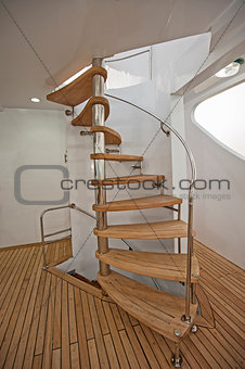 Wooden curved sprial staircase on sundeck of luxury yacht