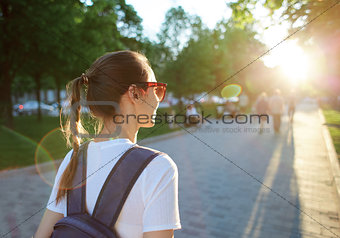 portrait of a young attractive woman with city backpack