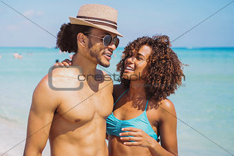 Couple standing and embracing at oceanside