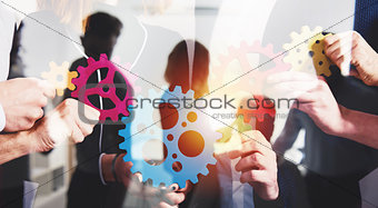 Business team connect pieces of gears. Teamwork, partnership and integration concept. double exposure