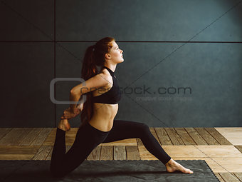Redhead woman doing kneeling quad stretch
