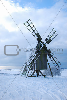 Old wooden windmill by winter season