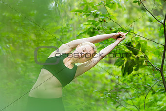 Lady practicing yoga in the nature.