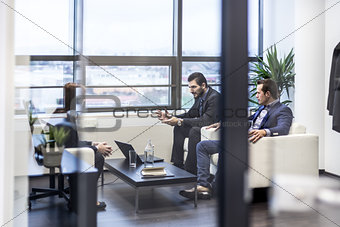 Business people sitting at working meeting in modern corporate office.