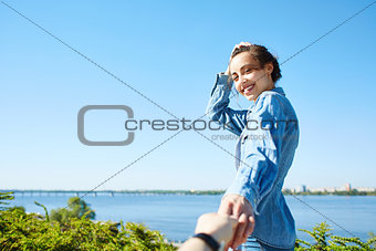 young attractive woman on the blue sky background