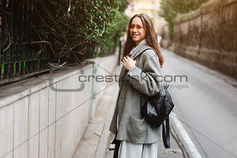 Beautiful young girl on a narrow street.