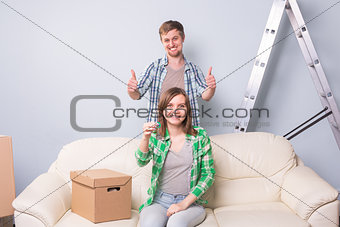 Young couple showing keys to new home