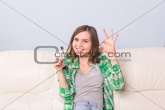 Young woman with boxes and holding flat keys.