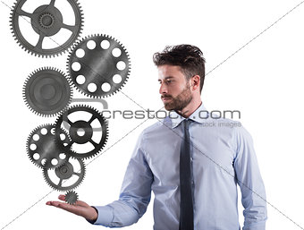 Businessman holds a gear system. Concept of business mechanism