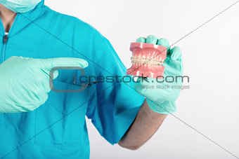 Dentist shows how to apply a brace