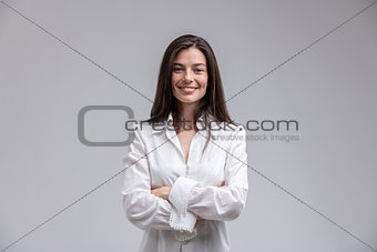 Smiling woman standing with arms crossed