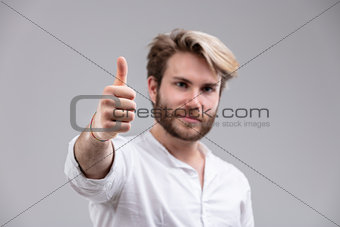 Man with stylish haircut showing thumb up