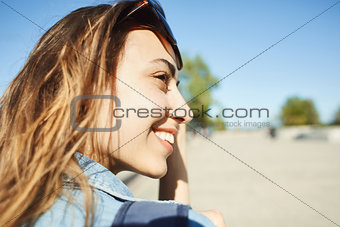 portrait of a young attractive woman walking city at sunny day