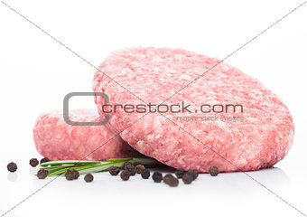 Raw fresh beef burgers with pepper and rosemarine