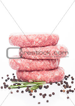 Raw fresh beef burgers with pepper and rosemarine