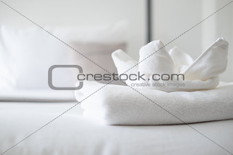 Close up on white towel on bed