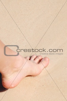 Foot on sandy beach