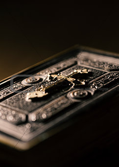 Precious antique Bible with golden cross close up