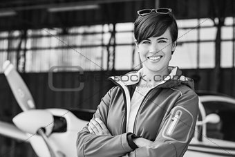 Smiling female pilot posing with her plane