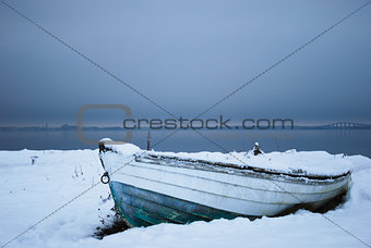 Winter paused old rowboat