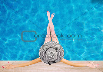 Girl with hat at the swimming pool. Concept of summer relax