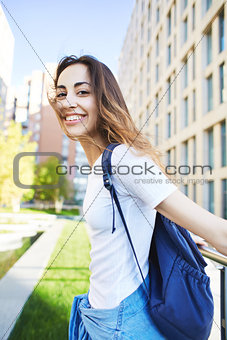 portrait of a young attractive woman on the cityscape background