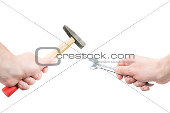 Hands with a hammer and wrench