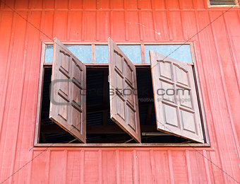 Wooden window is opened from the countryside house.