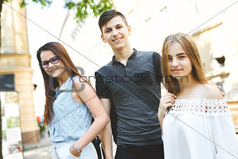 happy friends students perfectly spend time together on a walk on the street