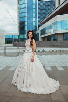 young beautiful bride outdoor on background of city