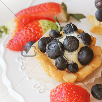 Tartlet with blueberries on white plate