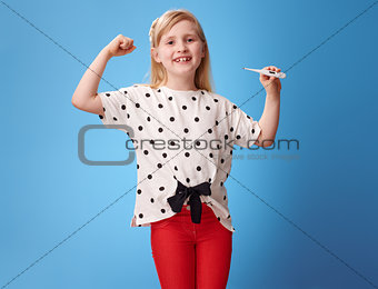 happy modern girl showing biceps and thermometer on blue