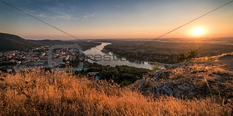 View of Small City with River from the Hill at Sunset