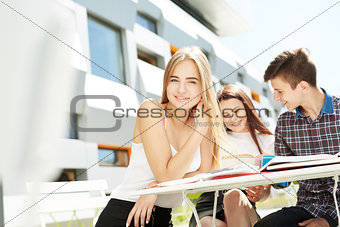 Portrait of young blondie girl with friends high school students
