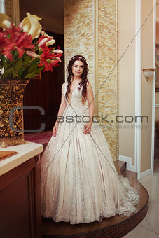young happy beautiful caucasian bride girl indoor in white dress
