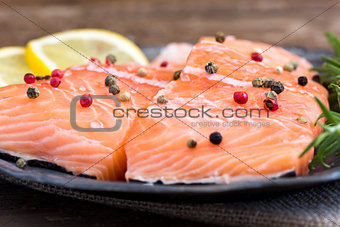 Raw Salmon Fish Fillet with Lemon, Spices and Fresh Herbs
